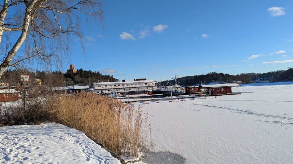 Winter view of Lilla Värtan, Stocksunds hamn, and the Södergrenska Tower on the hill
