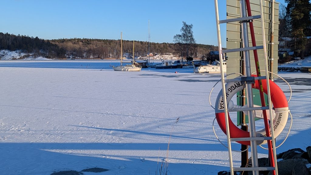 Frozen harbor with boats in Stocksund