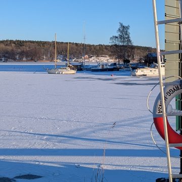 Frozen harbor with boats in Stocksund